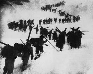 Italian Alpini carrying supplies over snowy pass